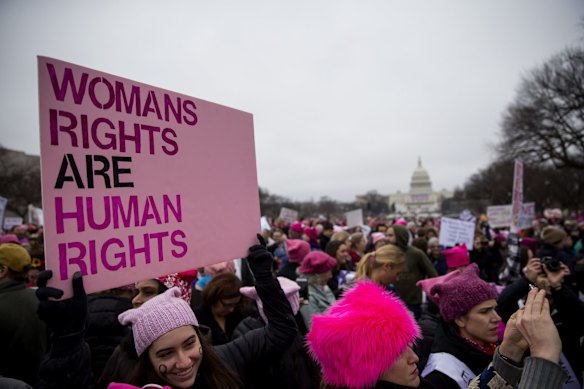 A demonstrator holds a sign while gathering on the National Mall during the Women's March on Washington in Washington, D.C.