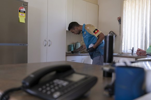 Booraja Home Care worker Ray Kelly, cleaning Veronic Holmes's kitchen in Moruya.