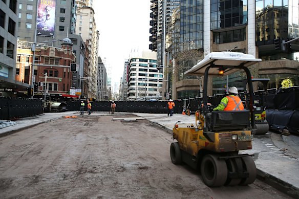 Workers prepare the road surface as progress continues on the Sydney Light Rail on the corner of Bridge and George St.