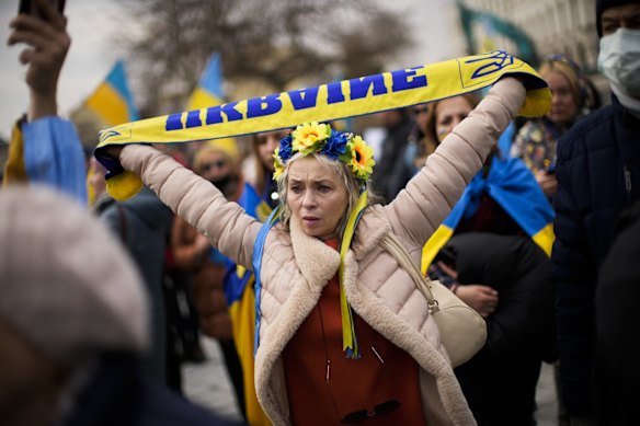 A woman holds up a Ukrainian scarf during a protest in Istanbul, Turkey on Sunday.