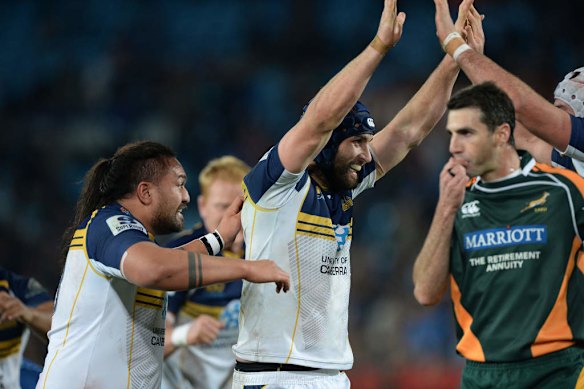 Brumbies players celebrate at the final whistle.