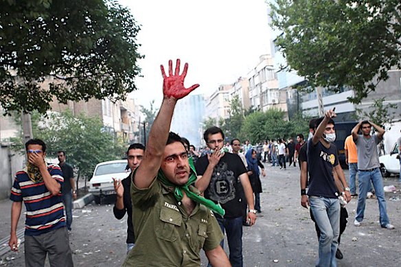 In this photograph posted on the internet, a man holds up his hand covered in blood during clashes between demonstrators and riot police in Tehran, Iran Saturday June 20, 2009.