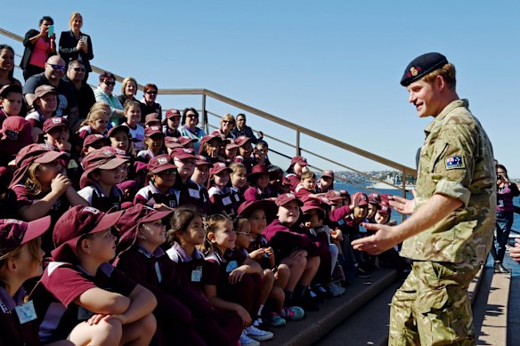 Britain's Prince Harry (R) speaks with students from St Marys South Public school during a visit to the Sydney Opera House