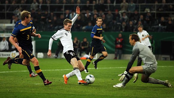 Mark Schwarzer of Australia saves from Andre Schuerrle of Germany in Moenchengladbach in 2011.
