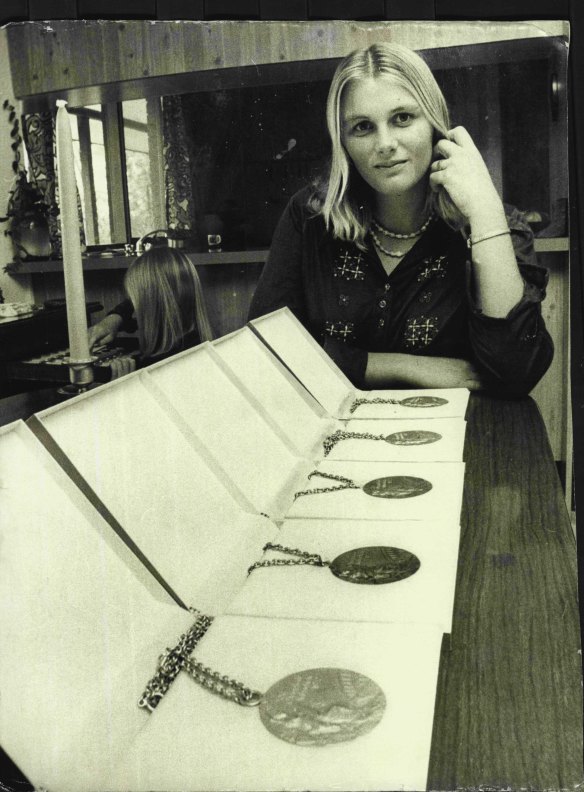 With her Olympic medals in 1975.