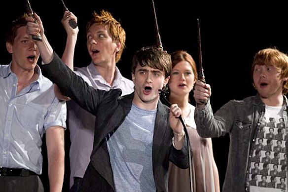 Daniel Radcliffe and members of the cast of Harry Potter wave their wands during the grand opening celebration for The Wizarding World of Harry Potter at Universal Studio Resort in Orlando, Florida.