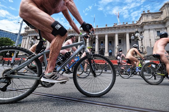 Cyclists ride past Parliament during the World Naked Bike Ride in Melbourne.