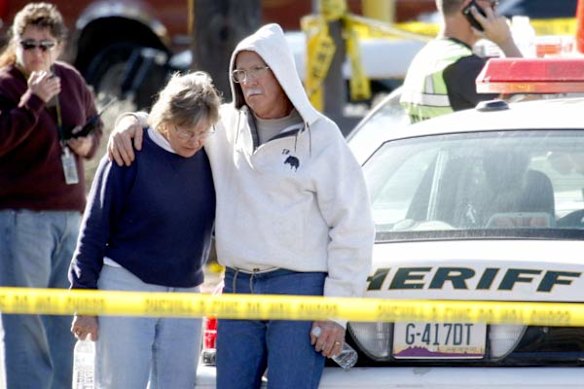 Bystanders gather at the shopping centre where a gunman opened fire.