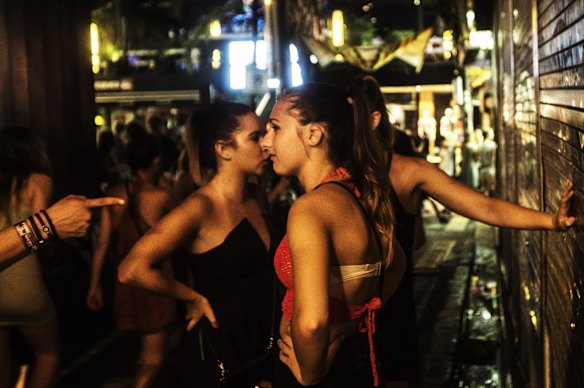 Schoolies in Bali are seen walking down an alley, near the main nightclubs in Legian, 2014.