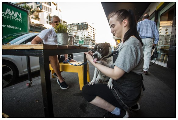 Miss Maudie greets the waitress at Creme Cafe, Bay St, Port Melbourne. 