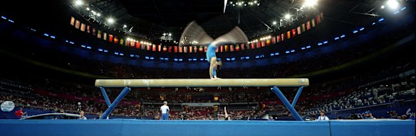A gymnast from the Ukraine practices on the beam during training in front of a packed audience at the Superdome.