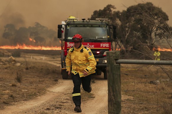 RFS firefighters working to protect properties as the North Black Range bushfire threatens properties at Bombay, NSW.