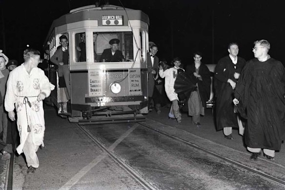 University students hold up the last Dulwich Hill tram on City Road in September 1957.