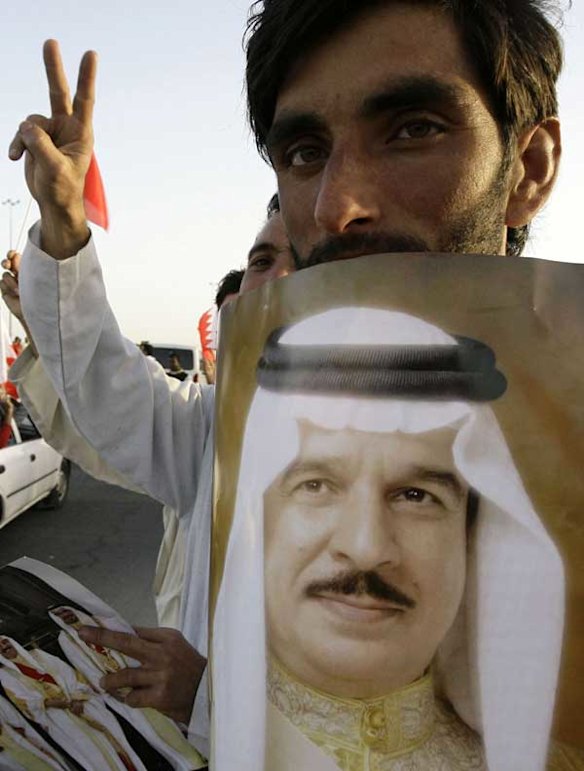 A Bahraini government supporter holds a picture of King Hamad bin Issa al-Khalifa during a pro-regime rally.