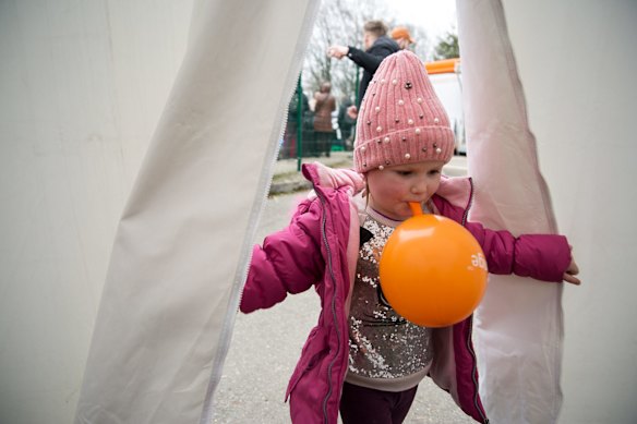 A girl plays in a tent set up by the local Slovak Red Cross in Ubla on Saturday after arriving with her family from Ukraine.