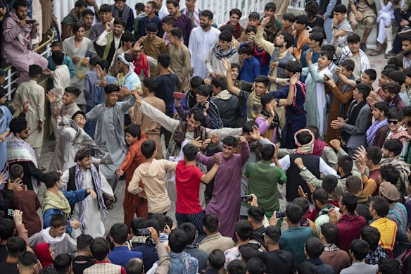 Afghans dance at Kabul City Amusement Park on the first day of Eid Al-Adha holiday in Kabul, Afghanistan. 