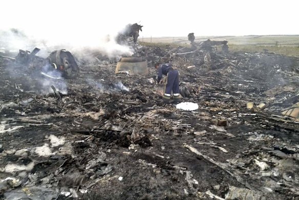 An Emergencies Ministry member works at the site of a Malaysia Airlines Boeing 777 plane crash.