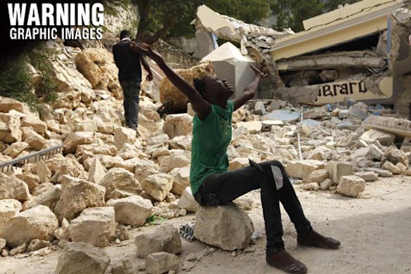 Cindy Terasme screams after seeing the feet of her dead 14-year-old brother Jean Gaelle Dersmorne in the rubble of the collapsed St. Gerard School in Port-au-Prince.