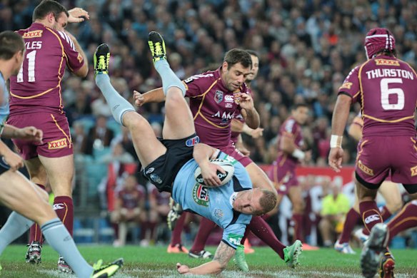 Luke Lewis is tackled.