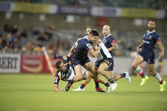 The Rebels' Jack Maddocks tries to break free from he Brumbies' Tom Banks and Andy Muirhead. 