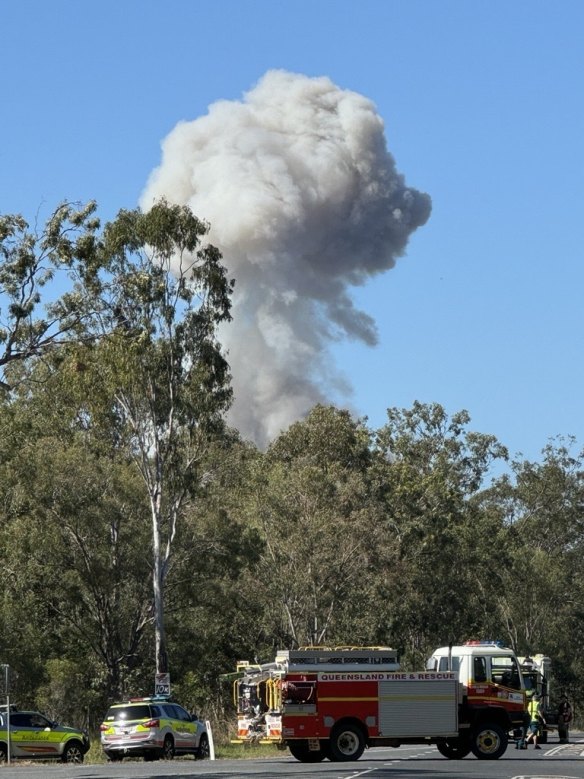 A smoke plume is seen near the Bruce Highway after the collision this morning.