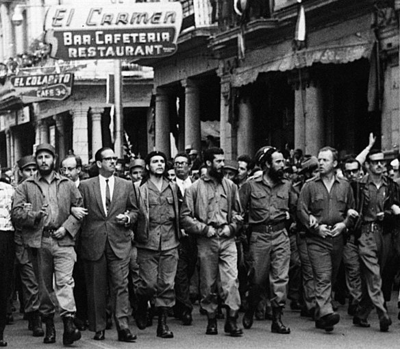 In this March 5, 1960 file photo, Cuban leaders walk arm-in-arm at the head of the funeral procession for the victims of the La Coubre explosion, blamed by the Cuban government on a US bomb attack on the Cuban ship La Coubre in the harbour of Havana.