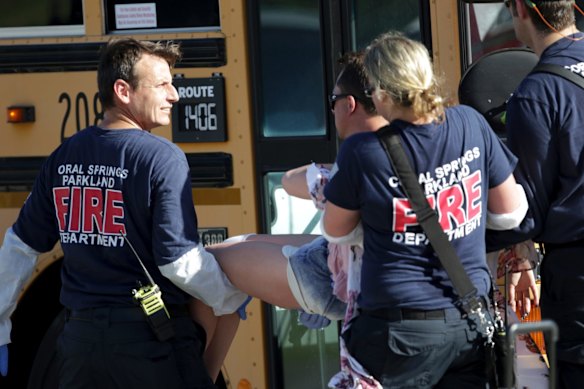 Medical personnel tend to a victim following a shooting at Marjory Stoneman Douglas High School in Parkland Florida.