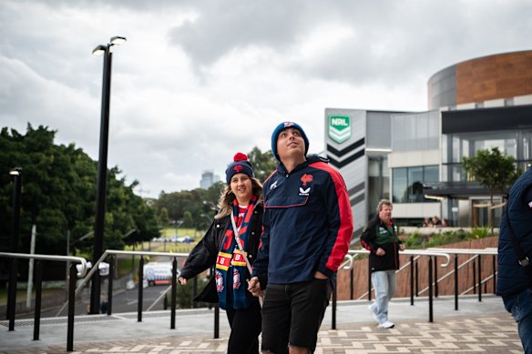 Roosters fans arrive under cloudy skies.