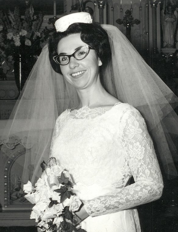 The '60s bride accessorised with pillbox hats propped atop her veil. 