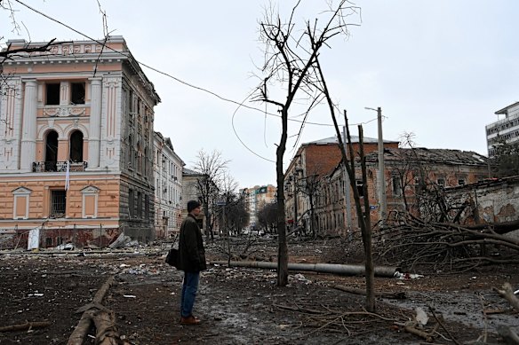 A man looks at the damage in a street after bombing that hit the military police building in the city centre of Kharkiv on the night of March 6.