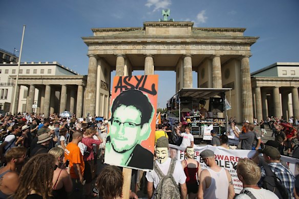Global perceptions matter too. Ex-NSA contractor Edward Snowden's disclosures have put the US on the defensive over cyber operations. A participant holds up a picture of Snowden with the German word for "asylum" during a 2013 protest in Berlin. 
