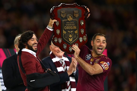 Johnathan Thurston and Cameron Smith of the Maroons hold aloft the Origin trophy after winning game three of the State Of Origin series.