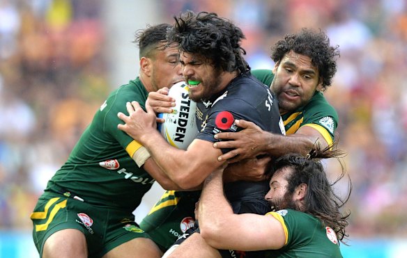 Tohu Harris of the Kiwis is tackled by a trio of Aussies at Suncorp Stadium. 