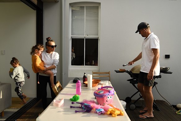 Jacky Ghossein and Sam Scotting, with their daughters Florence and Grace during dinner in the yard of their home in Balmain.