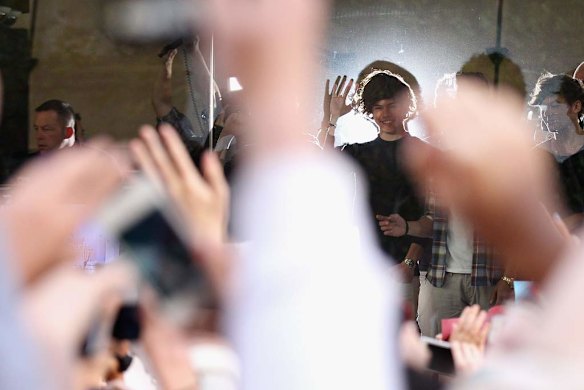 Halo effect ... One Direction look out to fans during their visit to Sunrise Martin Place studio.