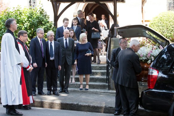 The sons of Lady Mary Fairfax, (L-R Warwick Fairfax, Garth Symonds, and Charles Fairfax) watch as her coffin is loaded into the hearse at her funeral in Darling Point, Sydney. 22nd September 2017.