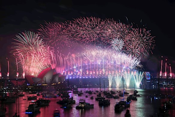 The New Years Eve Midnight fireworks light up the Sydney Harbour Bridge and Opera House.
