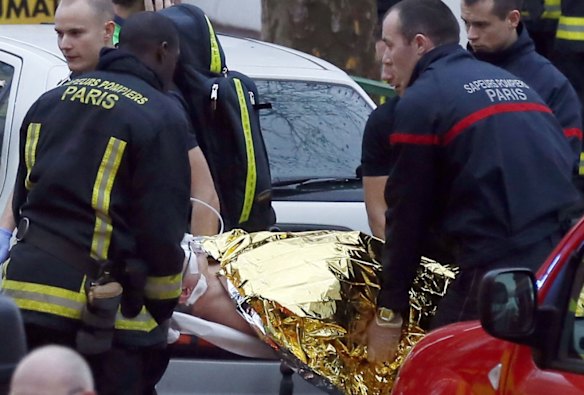 Police, paramedics and firefighters at the scene of the shooting in the south Paris on Thursday, January 8. 