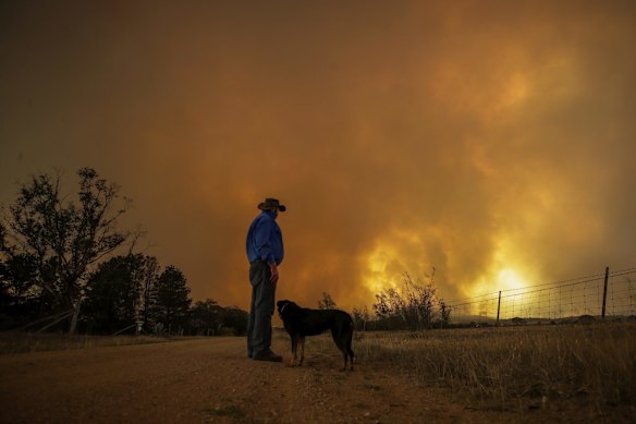Bombay resident Les Hart watches the North Black Range bushfire approach, seen near Bombay, NSW.