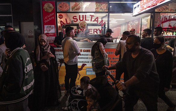 Crowds of people survey the food options.