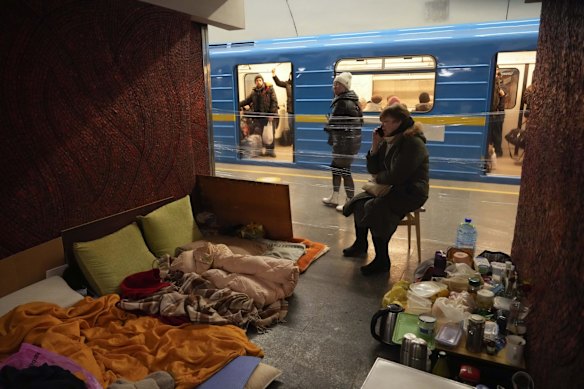 A woman makes the most of what has become her temporary home in an underground train station.