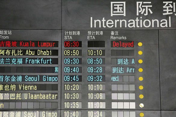 The arrival board at the International Airport in Beijing, China shows a Malaysian airliner is delayed.