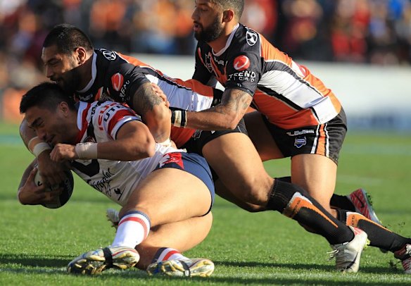 The Roosters' Adam Henry goes down in a hail of Tigers.