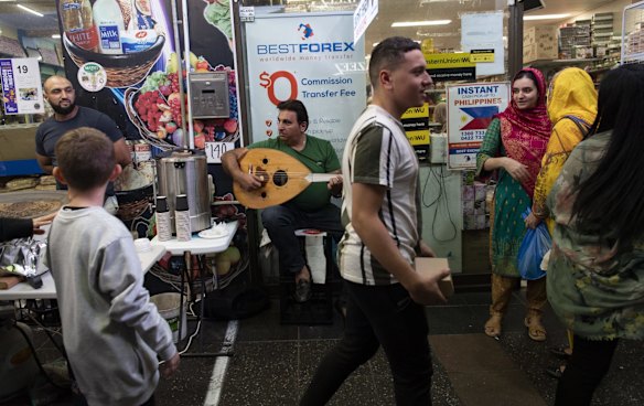 A busker plays for the crowds in  Haldon Street.