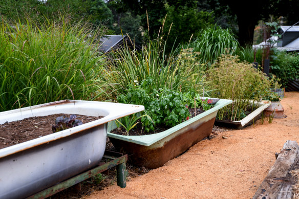 Old baths are used as raised beds in the kitchen garden