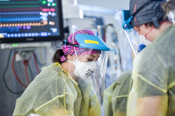 ICU nurses at work on a patient.