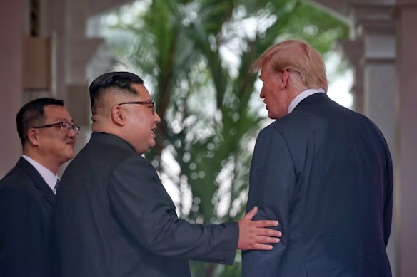 North Korea leader Kim Jong Un and U. S. President Donald Trump stand together at the Capella resort.