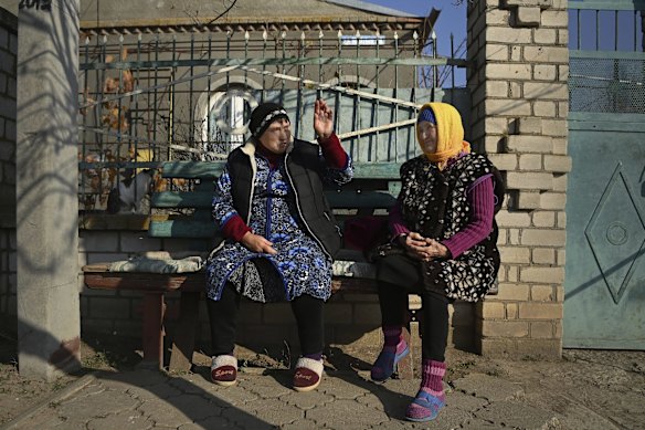 In Bilozirka, Lubov Poherelova, 66, and Nadiya Dukhova, 76, in front of the home where they both live. Their children are married and they refuse to leave their home. Bilozirka was liberated in March from Russian occupation and continues to be under constant threat of return fire from Russian troops.
