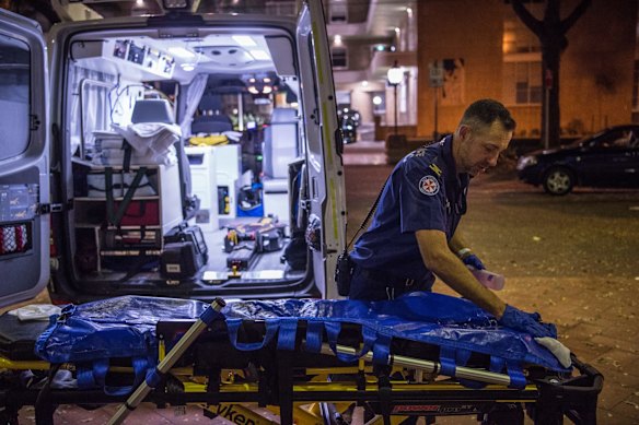 11:38pm. NSW Ambulance Paramedic Eugene Roser cleans the trolley after transporting a 70 year old male from Leichhardt to RPA Hospital. 