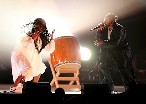 Kendrick Lamar (right) opens the 60th Grammy Awards.